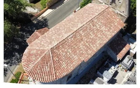 Church apse roof after moss removal, aerial drone view, maintenance for a local authority