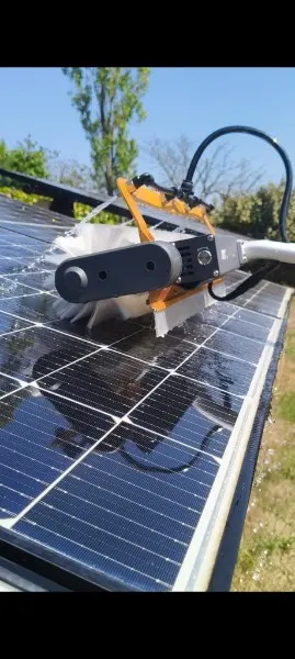 Solar panel cleaning with an electric brush